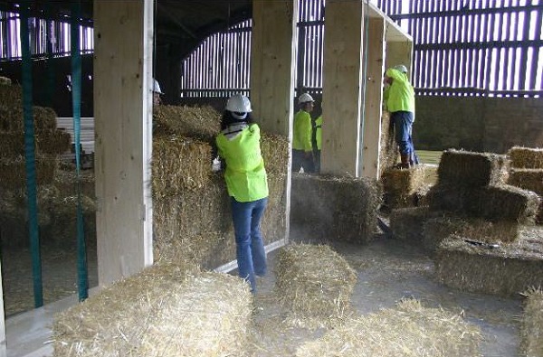Straw being fitted into a prefab frame.